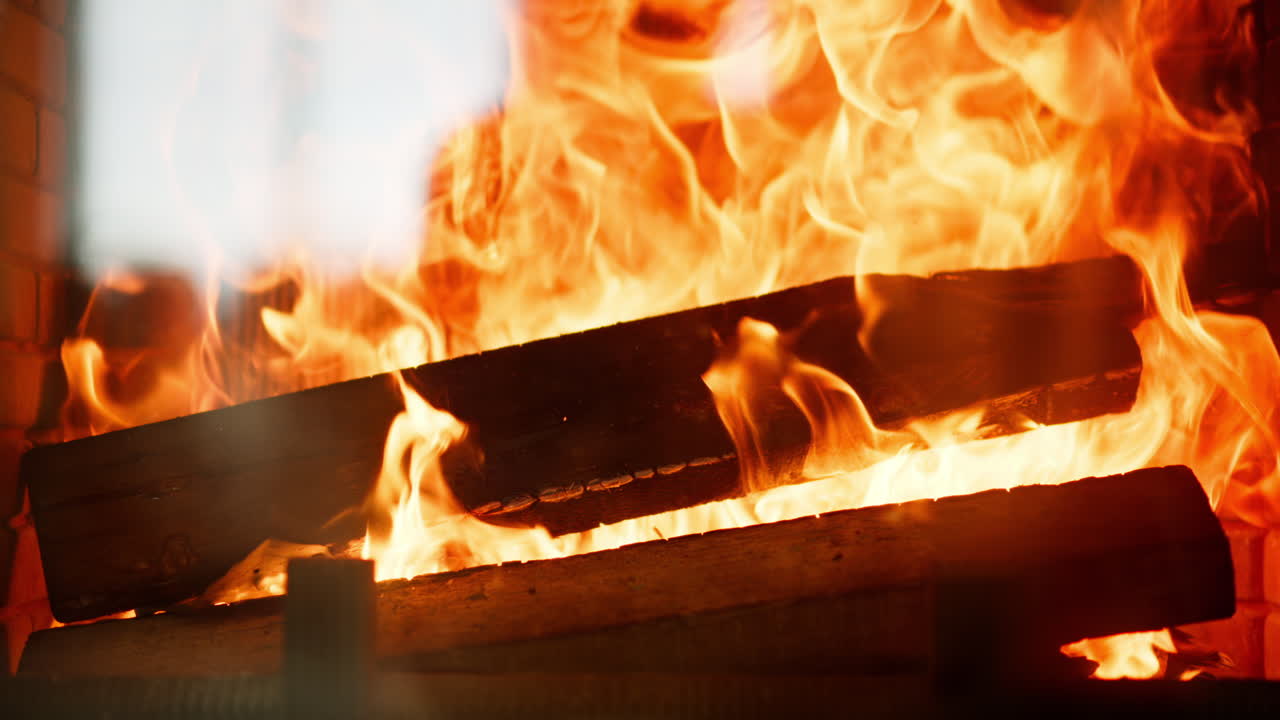Close up of wood burning with a strong flame in a fireplace