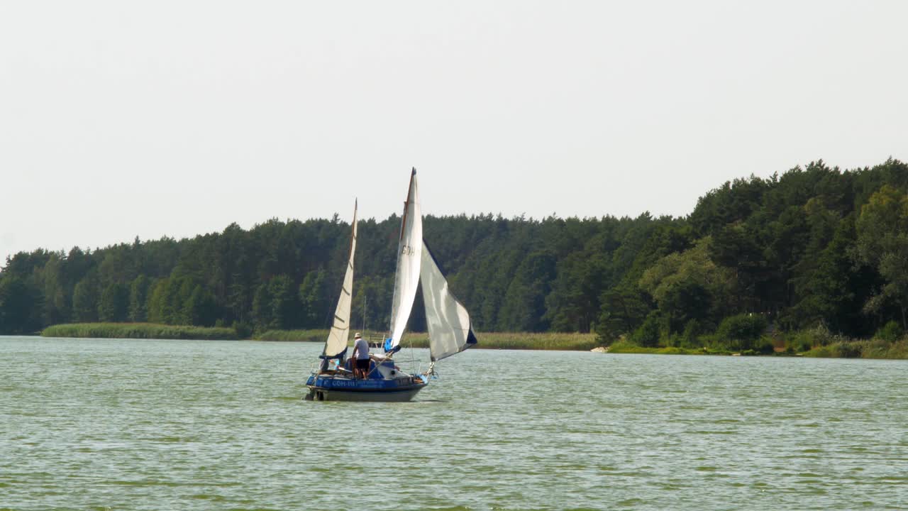 two-masted  Yacht sailing in Wdzydze Lake in Kaszubski park krajobrazowy in Pomeranian Voivodeship