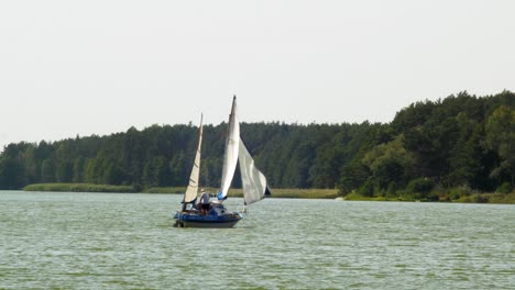 two-masted  yacht sailing in wdzydze lake in kaszubski park krajobrazowy in pomeranian voivodeship