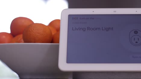 close up of a smart home hub device turning on a light in response to a voice command