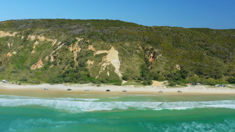 Aerial-View-Of-Cars-Driving-Along-Cooloola-Beach