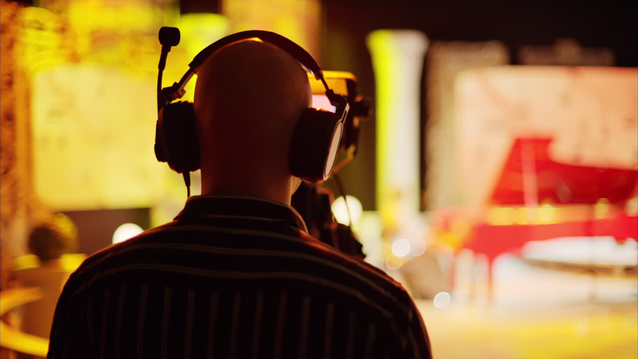 Man filming with professional camera on the backstage of a TV set
