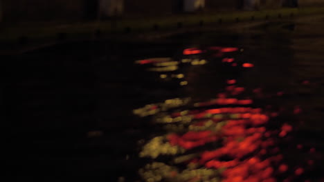 Close-up-view-of-river-wave-on-moving-boat-at-night-Amsterdam-Netherlands