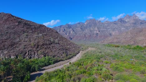 upward aerial to reveal detailed high desert mountain landscape and valley