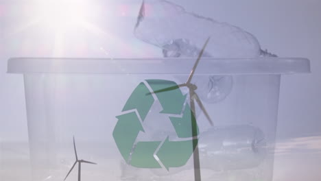 animación de una caja verde de reciclaje con cajas de plástico y turbinas eólicas