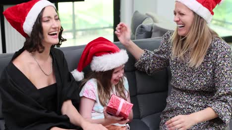 family and friends celebrating christmas with gifts