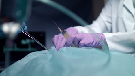 surgeon operating process. surgeon hands holding surgical tools