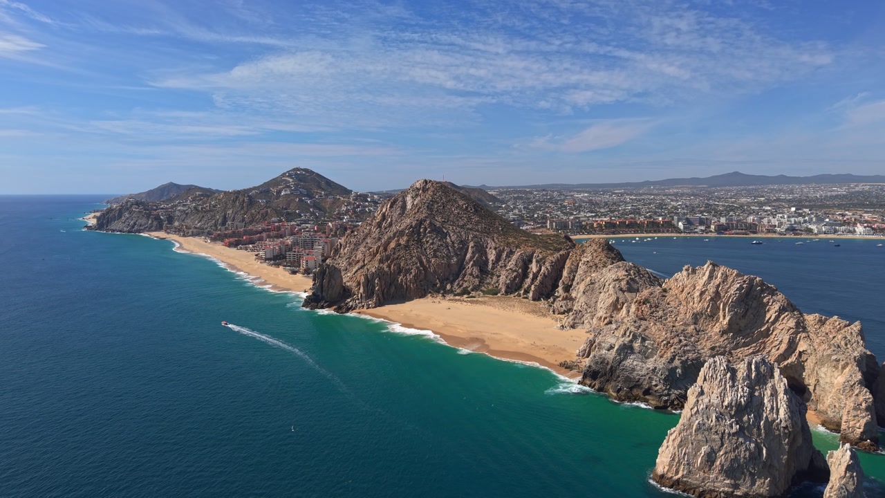 Flyover establishing shot between Lovers' Beach and Divorce Beach in the exclusive location of Cabo San Lucas, Baja California, Mexico