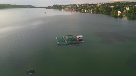 fishpen cage farming in clear water coastline during sunrise, philippines