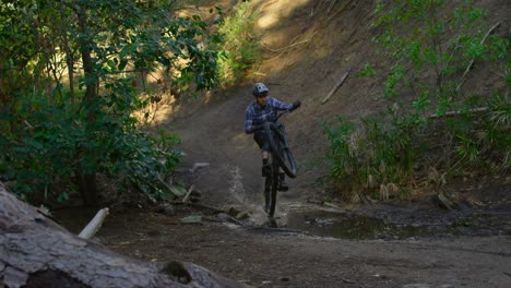 Man-riding-bicycle-in-forest-4k