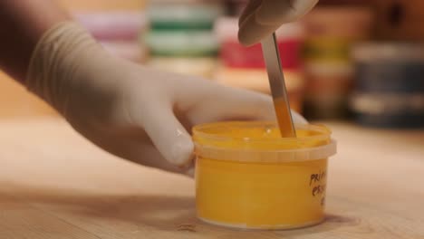 a worker kneads the paint for painting the walls