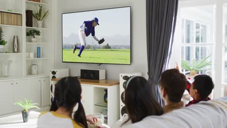 composite of happy family sitting at home together watching baseball game on tv