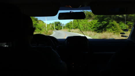 Driving-a-car-on-rural-road-with-a-lot-of-green-trees-around