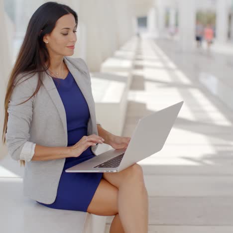 Businesswoman-relaxing-and-working-on-a-laptop