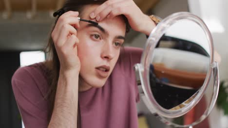 Caucasian-non-binary-transgender-woman-doing-make-up