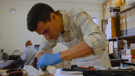 man cleaning bicycle parts on counter 4k