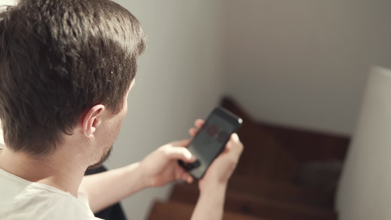 a young man uses a mobile phone and the Internet to buy online things