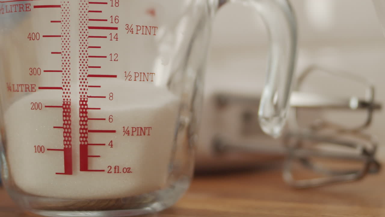 Measuring Sugar for Baking in Glass Jug, Dolly Slow Motion