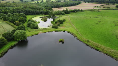 an aerial view of small fishing pools in the worcestershire countryside, england