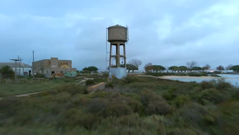 drone shot fly back abandoned water tank