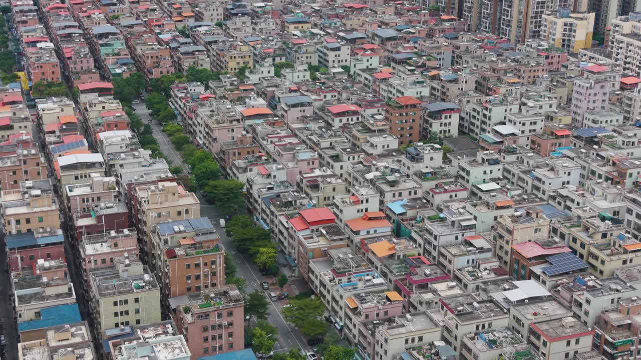 Close drone shot of Shenzhen’s Pingshan District, showing dense residential blocks, modern high-rises and urban development in South China