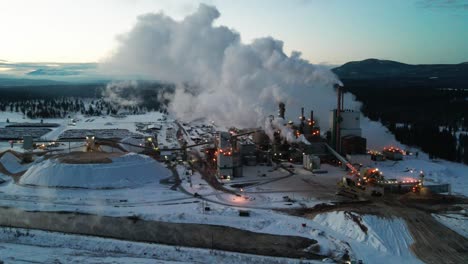 winter morning at pulp mill in cranbrook, british columbia: aerial view of industrial facility and specialized machinery transforming timber into wood pulp