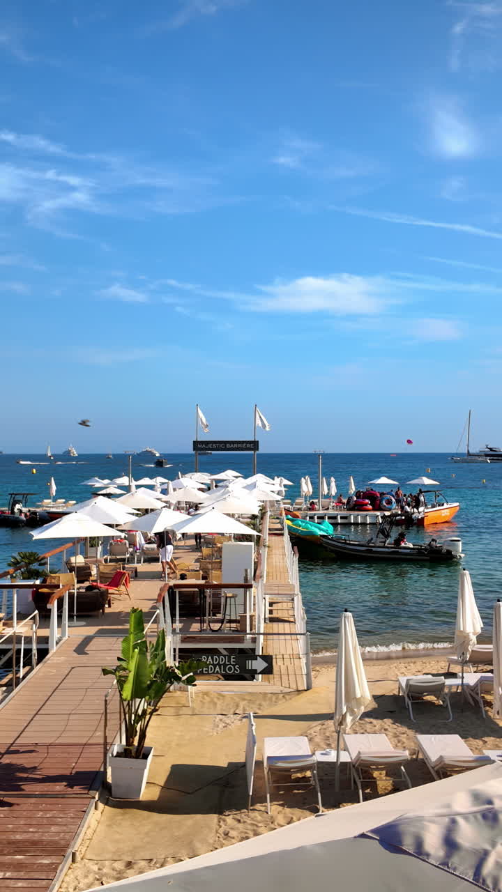 White umbrellas at a beach in Cannes, France. Vertical