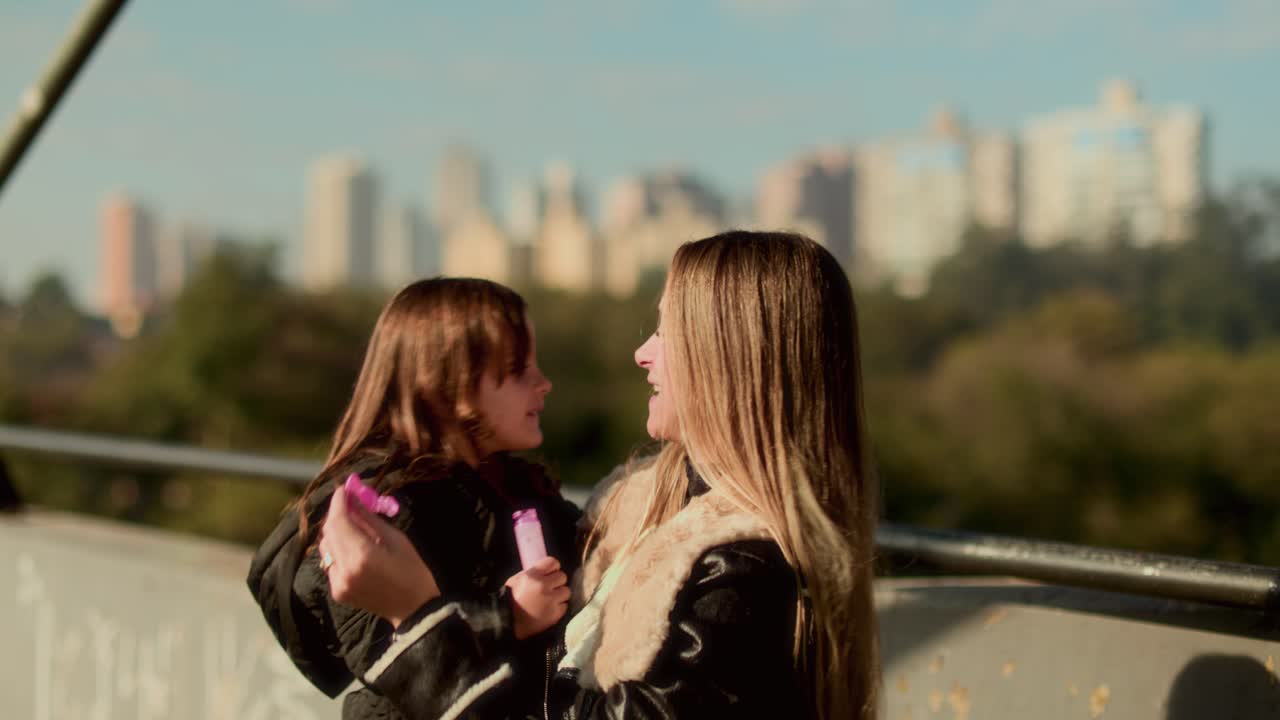 Mother and Child Joyfully Bonding Outdoors, Playing with Bubbles and Sharing Affection