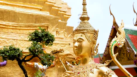 golden statue amidst temple surroundings in bangkok