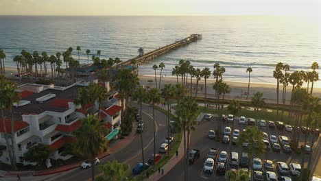 descending aerial approach of the pier in san clamente, california at sunset