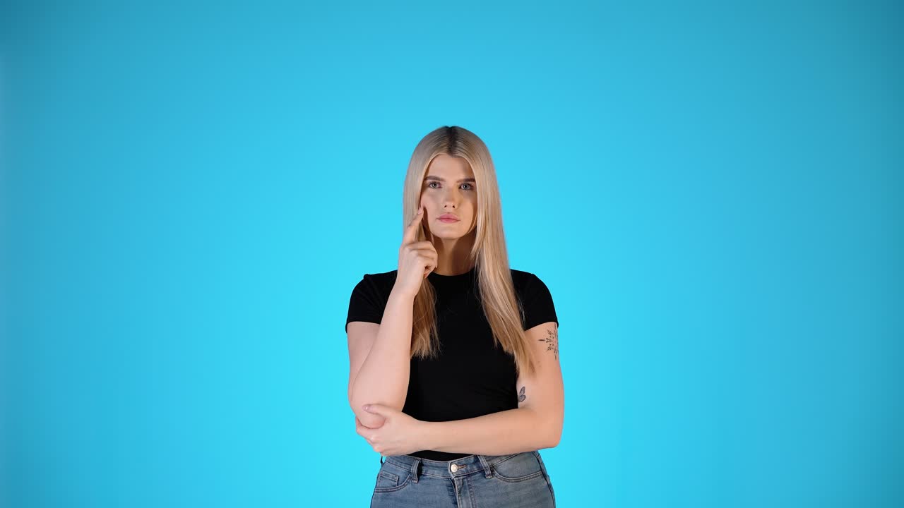 Thoughtful Young Blonde Woman, Thinking Gesture With Arms Crossed, Studio Portrait