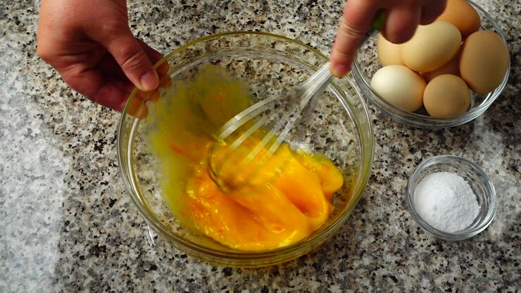 Beating of eggs in a bowl. Slow motion