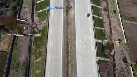 Tilt-up-revealing-drone-shot-of-the-Interchange-of-Samruddhi-Mahamarg-or-Nagpur-to-Mumbai-Super-Communication-Expressway,-an-under-construction-6-lane-highway