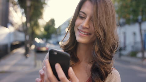 mujer hermosa usando una aplicación de tecnología de teléfono inteligente en la ciudad