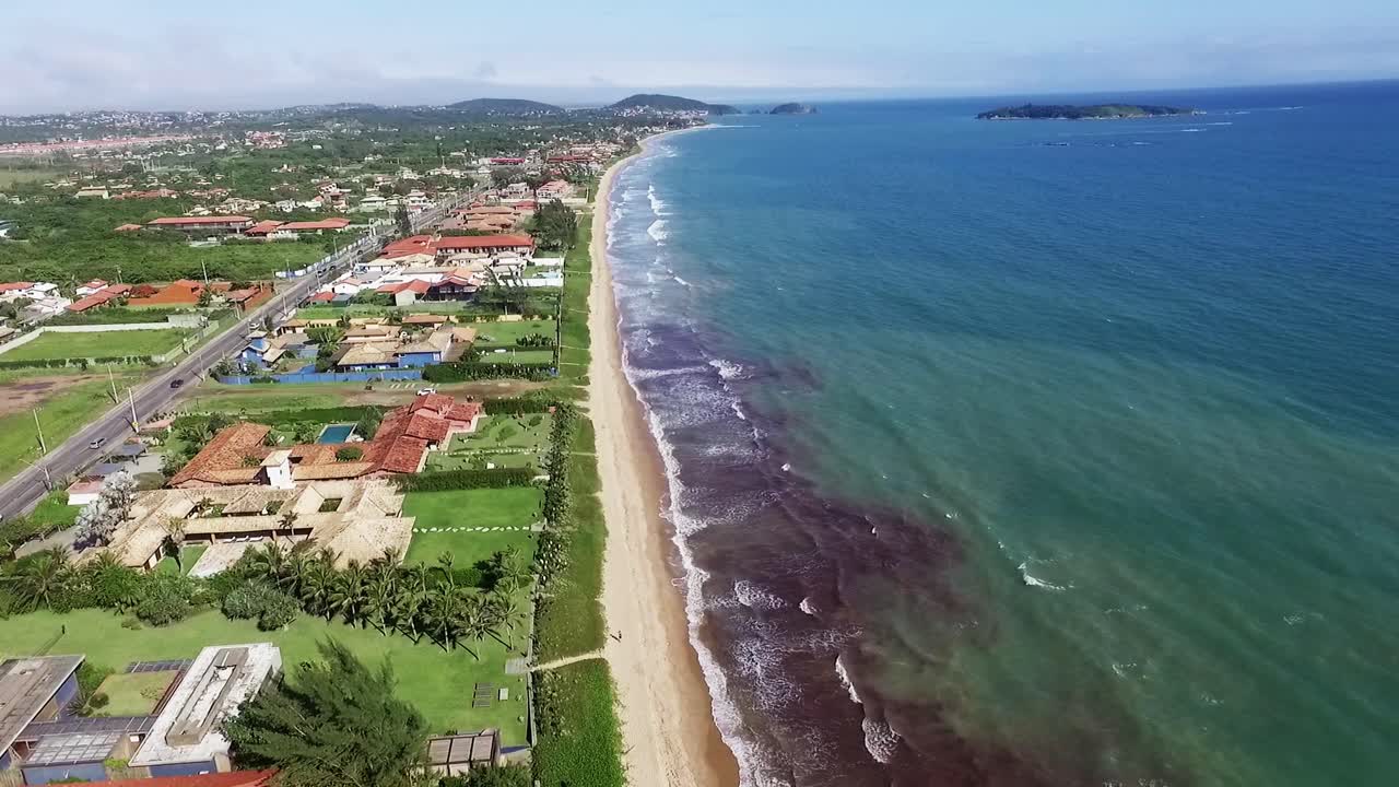 Capture the beauty of Búzios beach from the sky on a bright sunny day. Ideal for use in travel, tourism, and beach destination videos