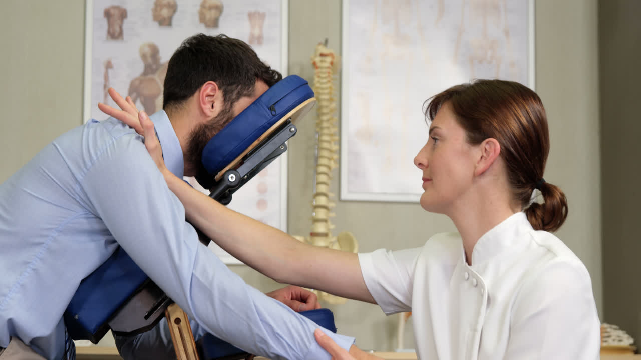 Female physiotherapist giving arm massage to a patient