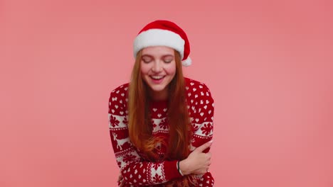 lovely positive adult girl in christmas sweater laughing out loud after hearing anecdote funny joke