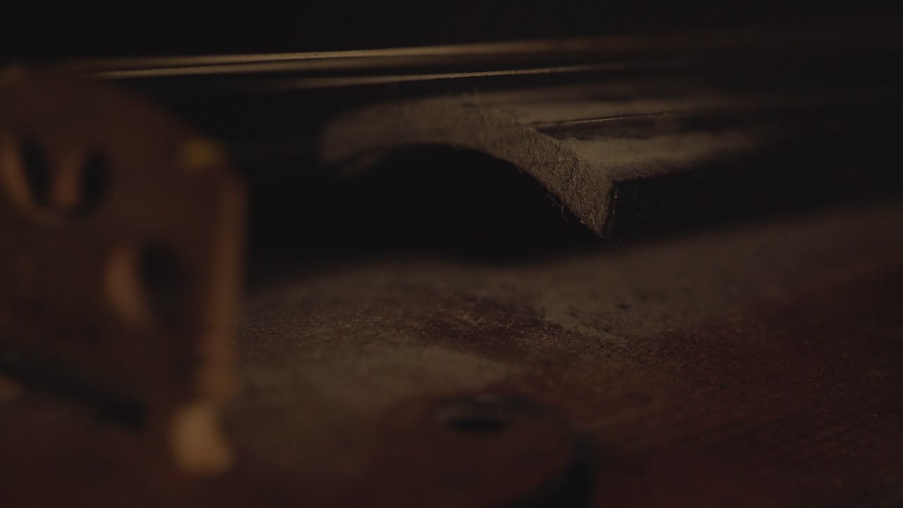 primer plano de violín antiguo, cambios de luz dramáticos sobre el instrumento, secuencias de video de música sinfónica clásica