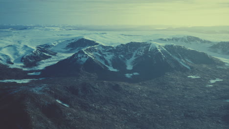 large-snow-patch-left-over-on-the-volcanic-rock-field-of-a-mountain-in-summer