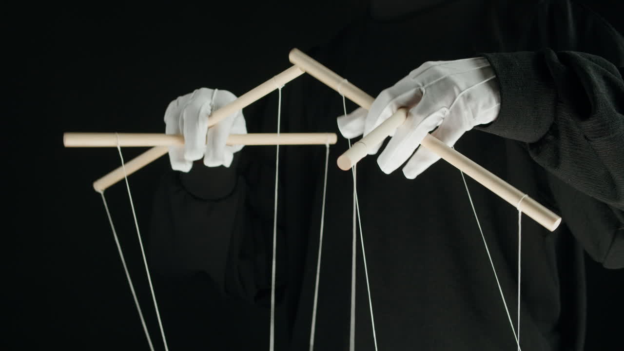 Close-up of Hands in White Gloves Operating Marionette Controls