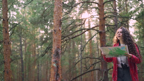 woman looking at map in the forest