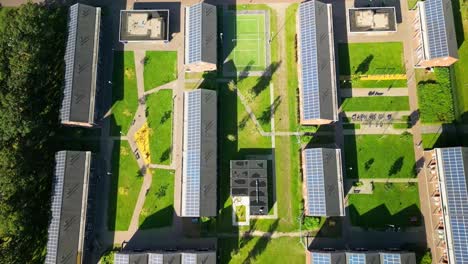 aerial view of eco-friendly apartment complex with solar panels