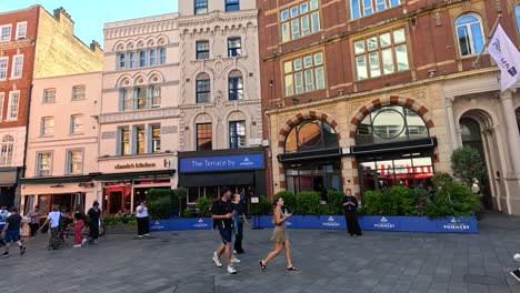 people walking past a historic building