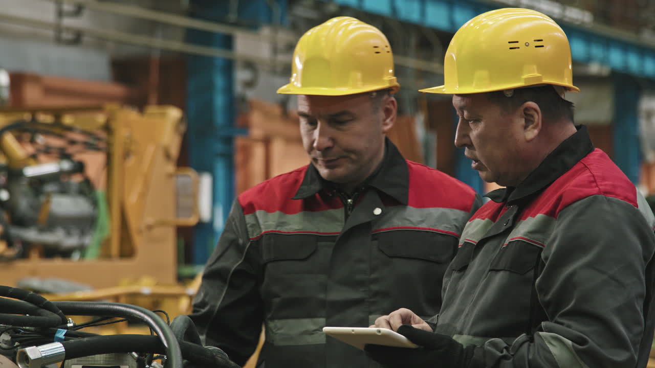 Plant Workers With Tablet Talking At Assembly Shop