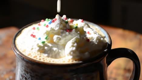 delicious hot beverage topped with whipped cream and colorful sprinkles, captured in a cozy setting, inviting warmth and indulgence