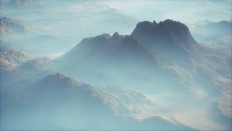 distant mountain range and thin layer of fog on the valleys