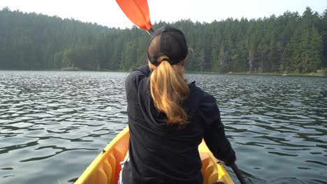 Woman-Kayaking-on-a-Lake-alone-at-Sunset
