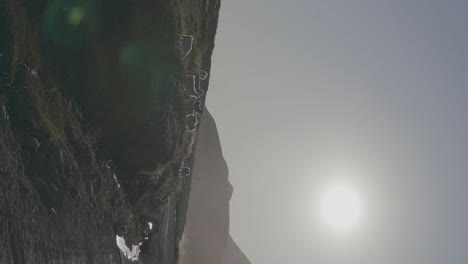 sheep grazing on a hillside with mountains in the background at sunrise in patagonia, argentina