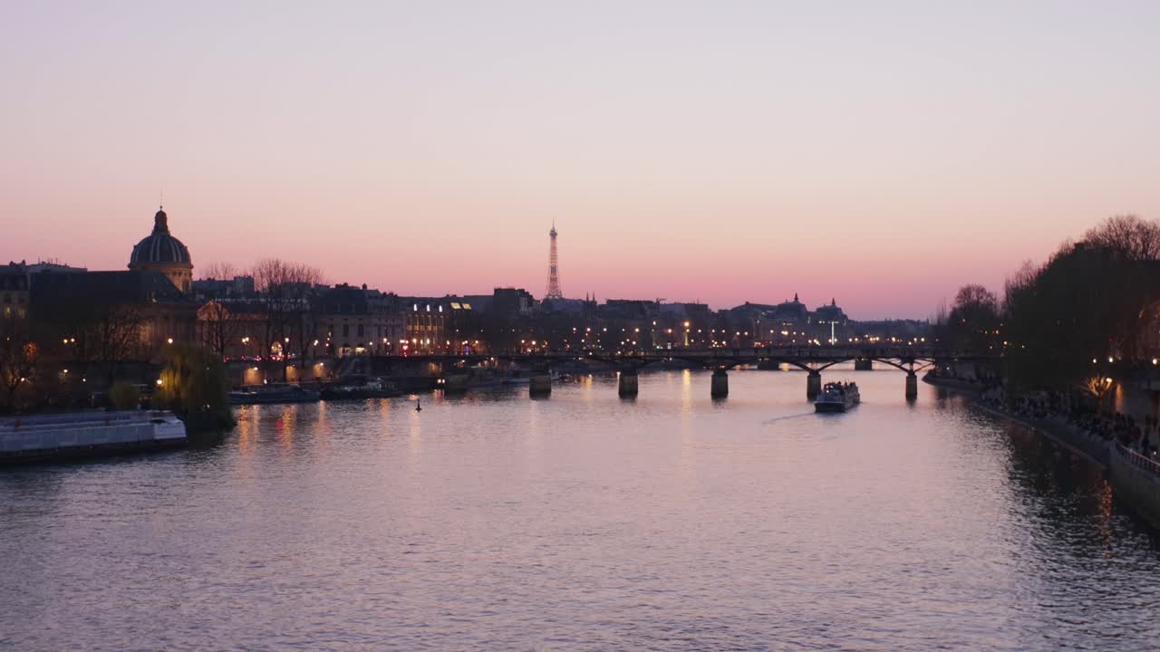 Calm static wide shot of Paris Seine river during sunset with touristic boats
