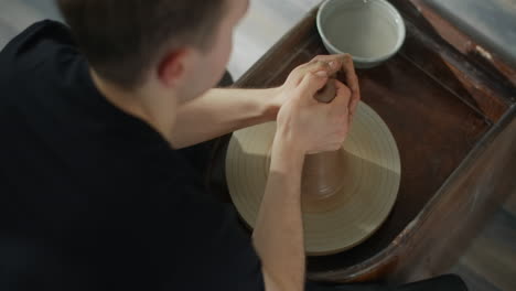 person working on pottery wheel